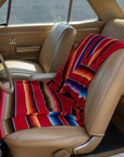 Car interior with a colorful blanket draped over the seats