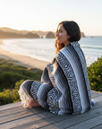 Model wrapped in blanket on coastal deck