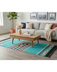 Living room with a gray sofa, wooden coffee table, and a colorful rug.