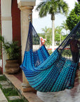 Mexican thick cord blue hammock hung between two pillars