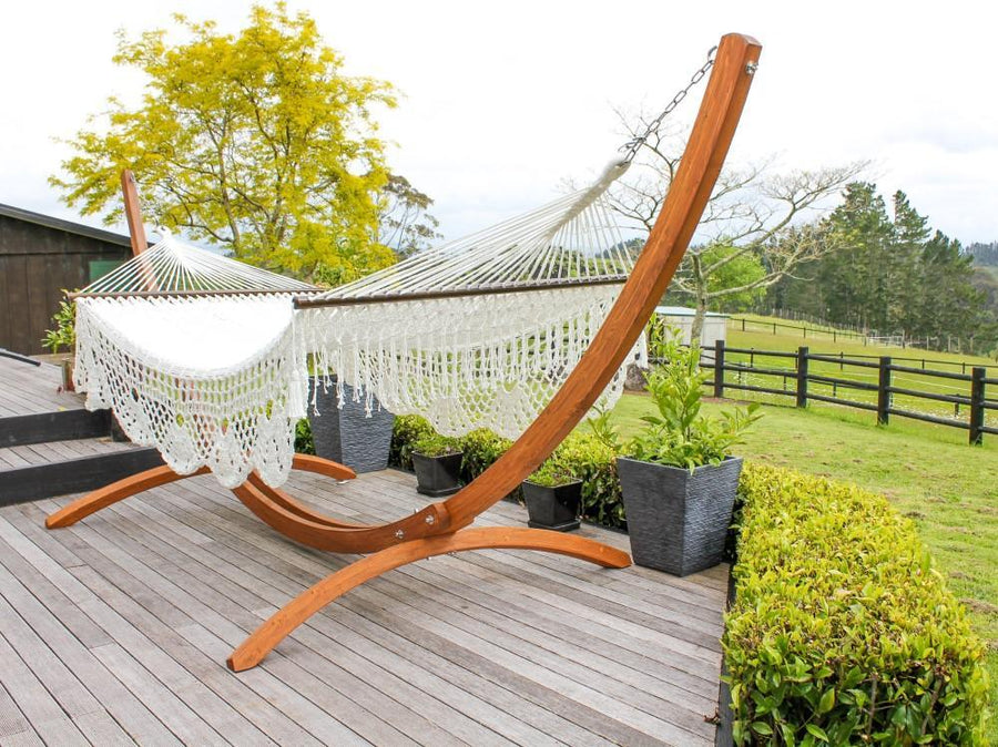 Polyester White Resort Style Hammock with Wooden Hammock Stand on Deck