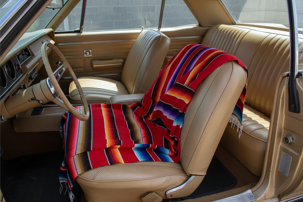 Car interior with a colorful blanket draped over the seats