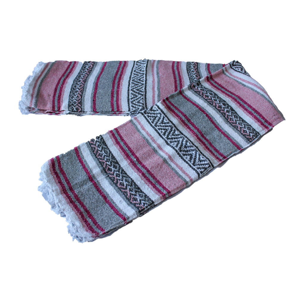A Mexican falsa blanket with pink and grey stripes, featuring intricate patterns and artisanal craftsmanship.