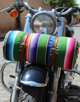 Motorcycle with colorful Mexican blanket straped to front on a cobblestone street