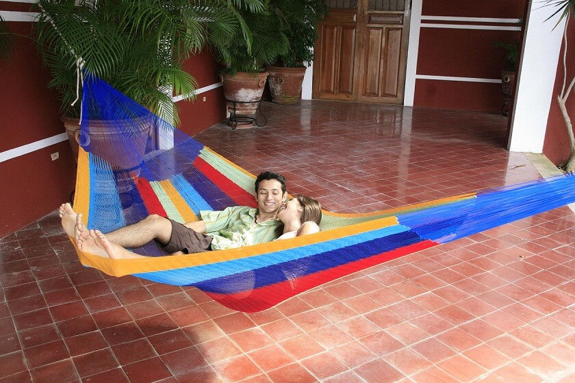 Mexican Traditional style hammock being shared by couple