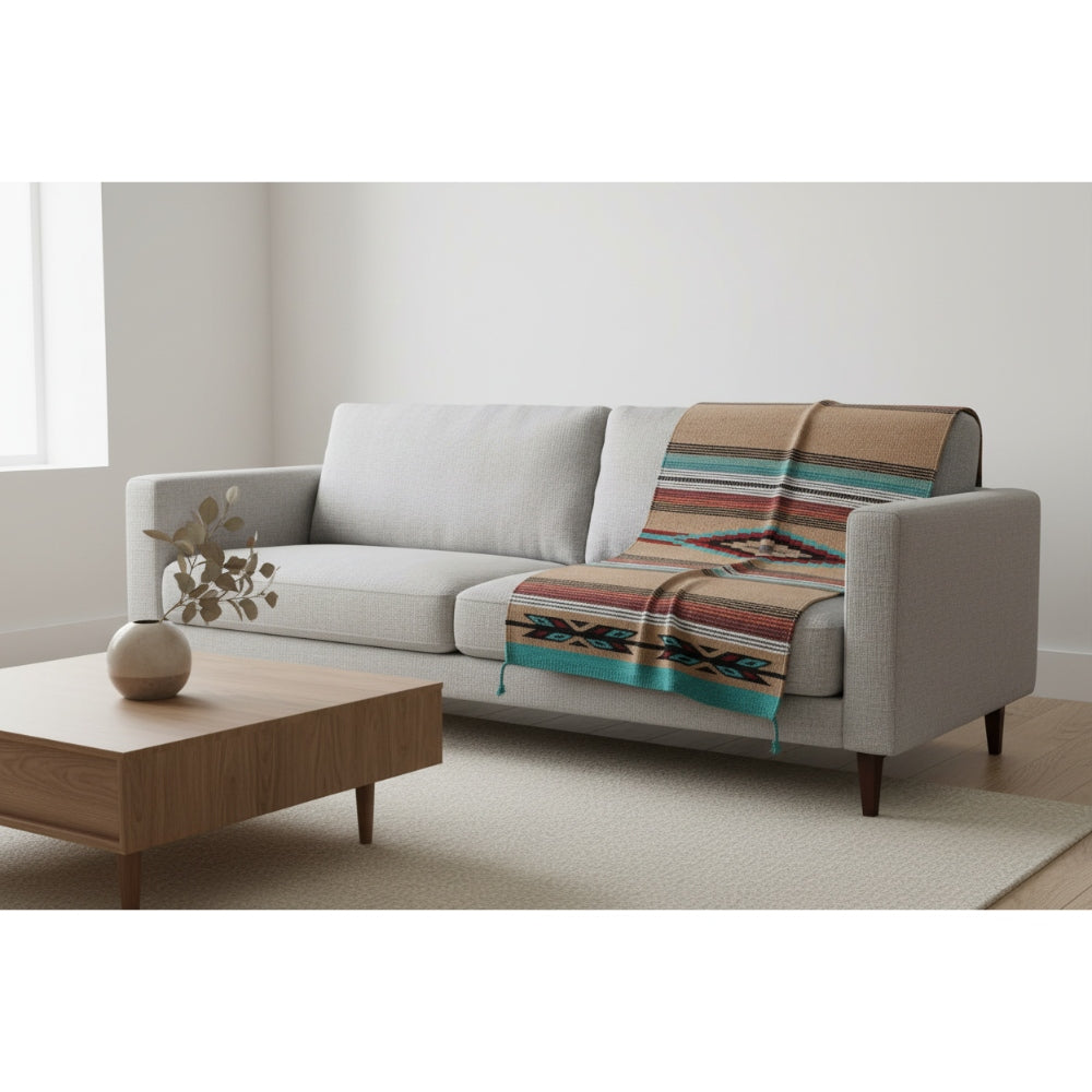 Sofa with a patterned throw blanket in a minimalistic living room.