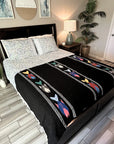 Bed with black and white patterned comforter featuring colorful fish designs in a bedroom setting.