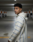 Man wearing a striped hoodie in a parking garage