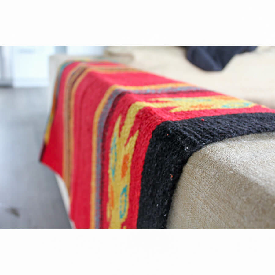 Red woven rug on couch