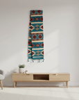 Decorative rug with geometric pattern hanging on a white wall above a wooden console table.