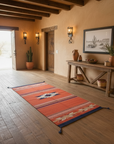 Nestled room with a wooden bench, rug, and wall decor in a rustic setting.