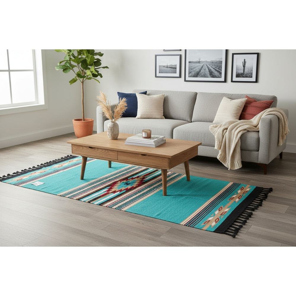 Living room with a gray sofa, wooden coffee table, and a colorful rug.