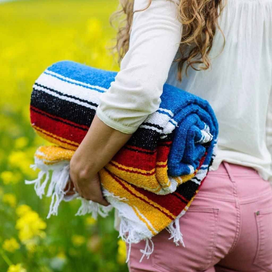 Rolled up Mexican yoga blanket - bright blue