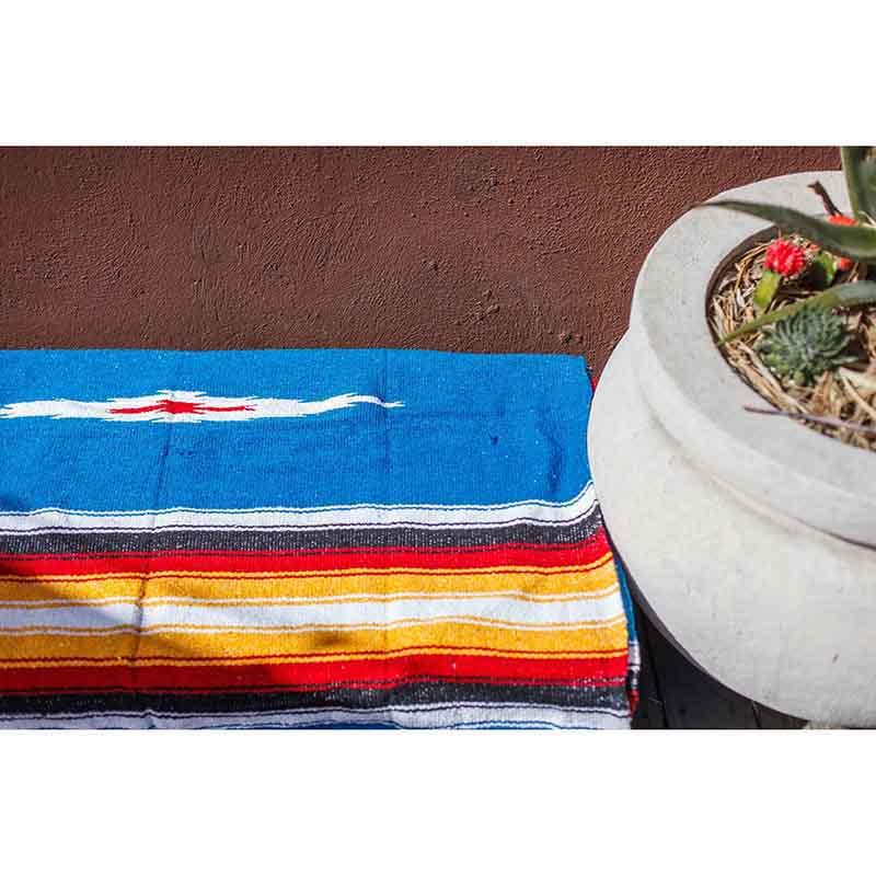 Blue Mexican rug on ground