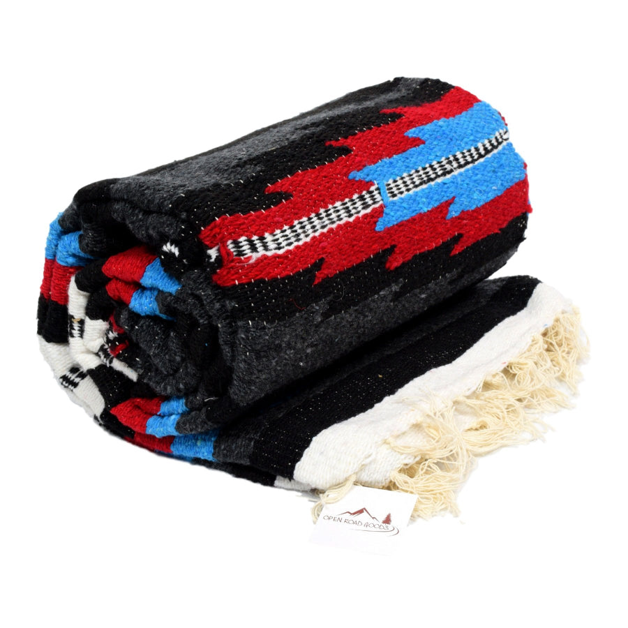 Rolled up saltillo Mexican blanket in dark colours