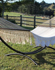 Spreader bar hammock and freestanding metal arc hammock stand