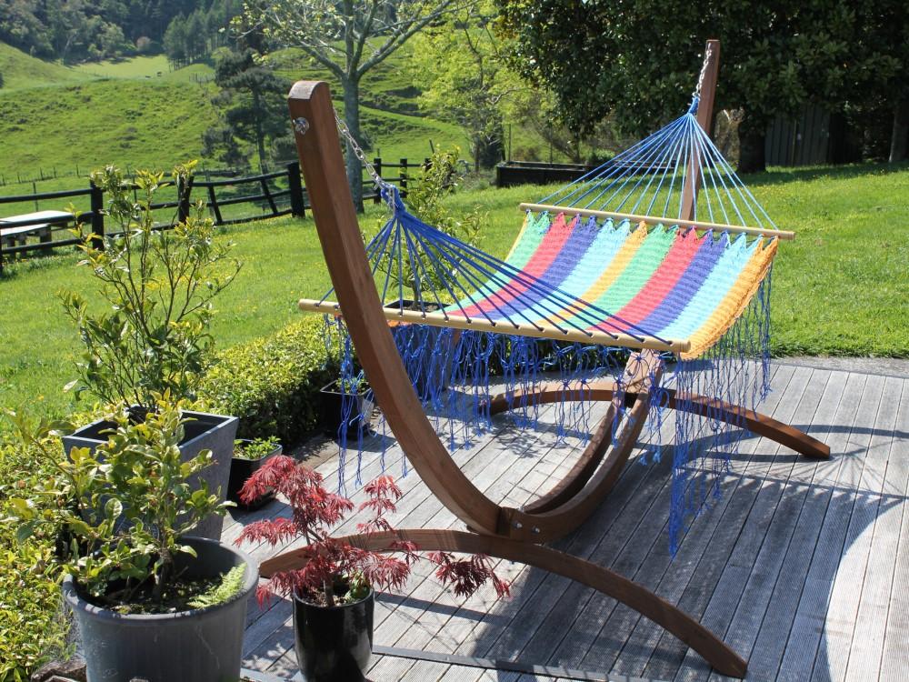Curved Wooden Hammock Stand with Brightly Coloured Mexican Hammock