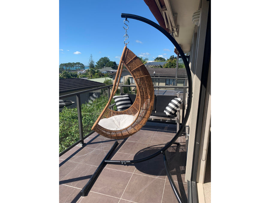 Curved chair hammock stand with egg hanging nest on balcony