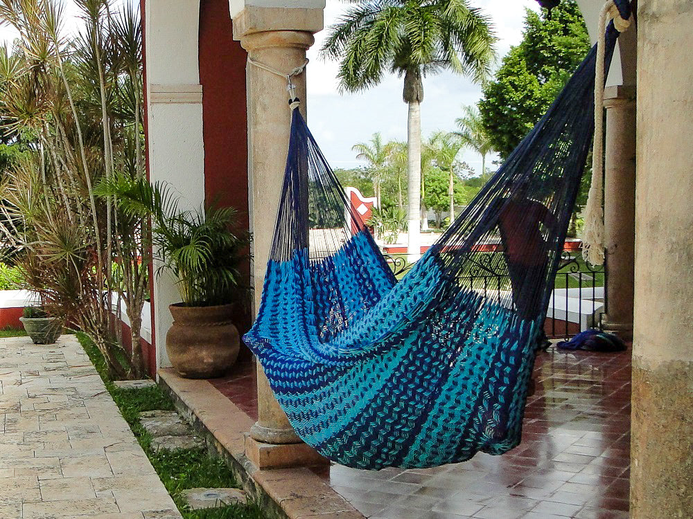 Mexican thick cord blue hammock hung between two pillars