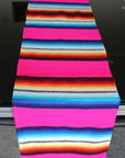 Pink striped table runner in Mexican style on glass table